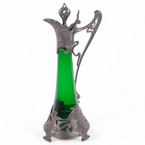 7 - WMF - an Art Nouveau Claret jug, with stylised pewter mounts and green glass body, H42cm