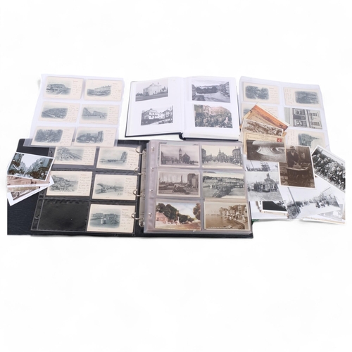 102 - A postcard album with over 200 Vintage postcards of Hastings, together with a folder of reprinted ph... 