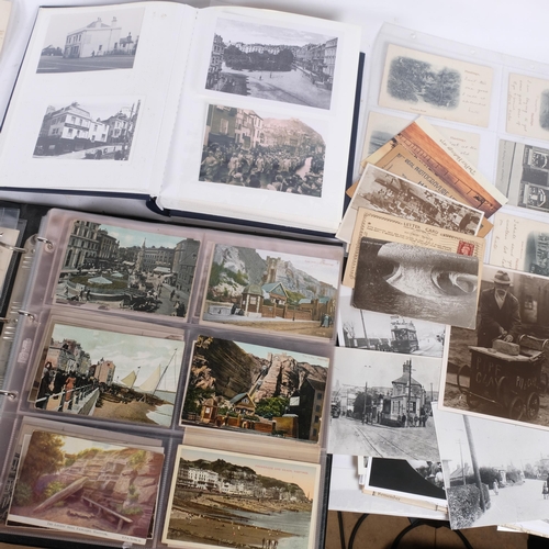 102 - A postcard album with over 200 Vintage postcards of Hastings, together with a folder of reprinted ph... 