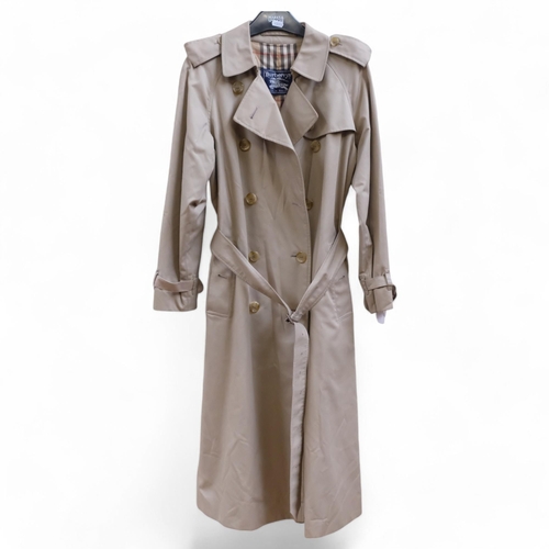 122 - A Burberry tan coat with check lining, size Small