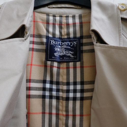 122 - A Burberry tan coat with check lining, size Small