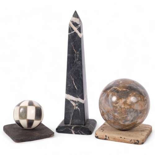 151 - A two-colour marble obelisk, H21cm, a specimen marble ball, and another (3)