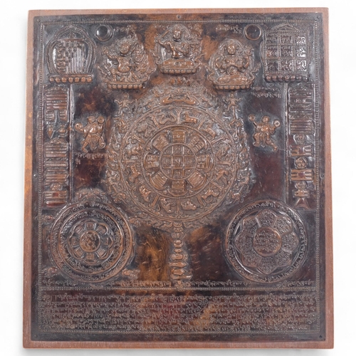 189 - A 19th century Tibetan Thangka, a repousse decorated copper panel depicting Buddhas with script, pan... 