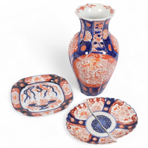 196 - A Chinese blue and red decorated Imari porcelain vase, height 30cm, and 2 similar Imari plates (1 br... 