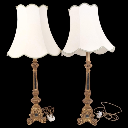 205 - A pair of carved giltwood table lamps with mirrored columns, and shades, height to top of bayonet 56... 