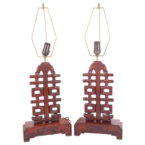 206 - A pair of Chinese design hardwood table lamps of lattice pierced and stepped form, H50cm