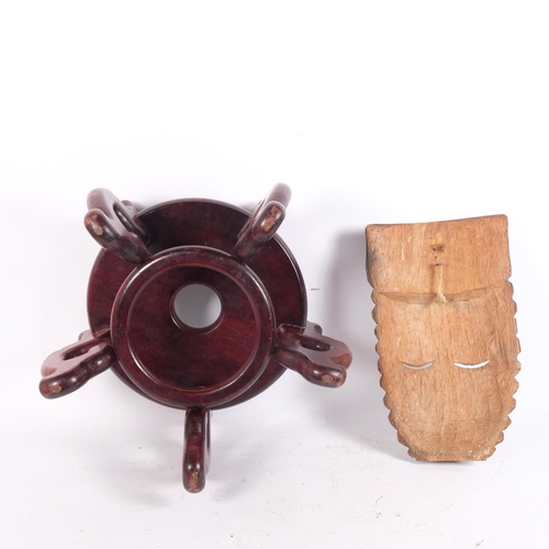 228 - A carved hardwood mask, and a Chinese hardwood jardiniere stand