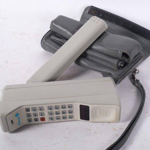 271 - A circa 1990s Stornophone 220 brick mobile phone, with battery pack, aerial and associated carry cas... 