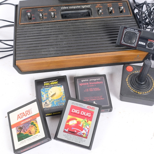 304 - A Vintage Atari 2600 computer games console, with various power cables and joystick controllers, a q... 