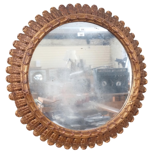 326 - A large circular wall mirror, in a carved giltwood acanthus leaf frame, diameter 85cm