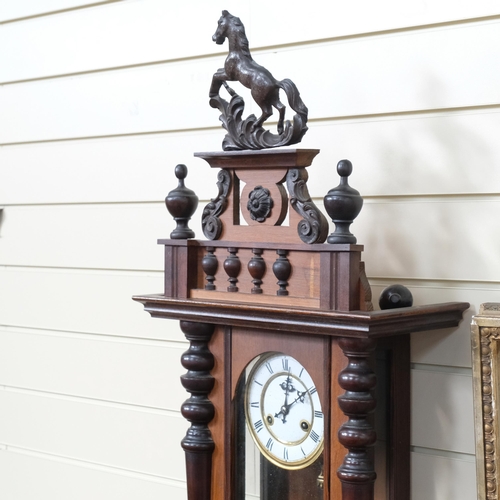 332 - An ornate walnut-cased Vienna regulator wall clock, with carved horse mounted decoration, height app... 