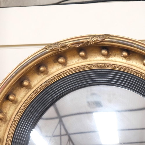 341 - A large Regency style giltwood convex wall mirror, with boss ball decoration, diameter approx 58cm