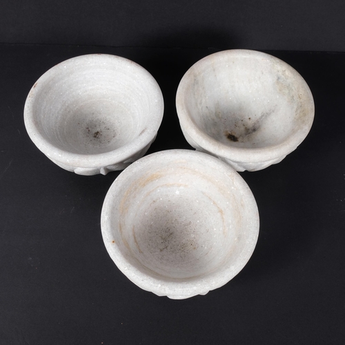 395 - A set of 3 carved marble bowls of lotus design, 15cm across