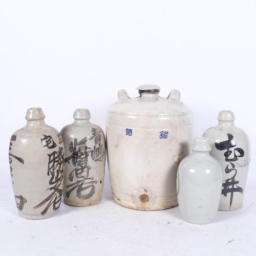 439 - A Japanese stoneware flagon with inscription, H32cm, and 4 Japanese Sake bottles