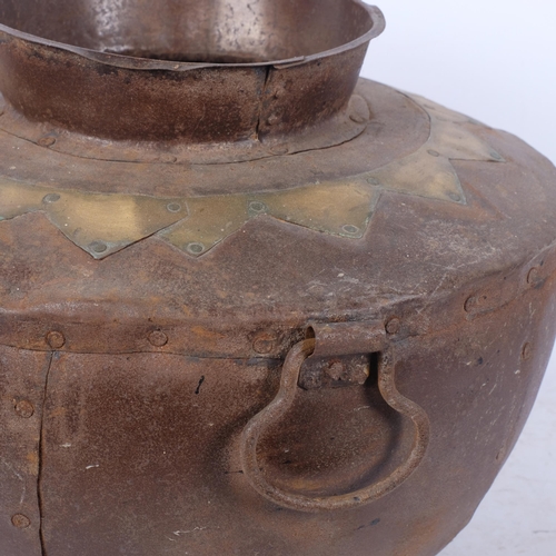 457 - A panelled steel pot with ring handles and brass decoration, 37cm across