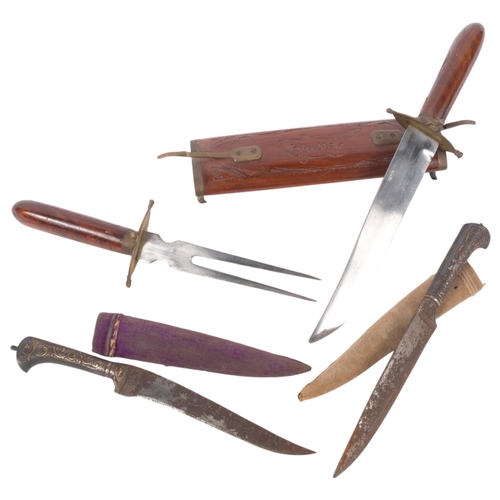 543 - An Indian teak cased carving set (knife and fork), and a pair of Middle Eastern knives, with brass i... 