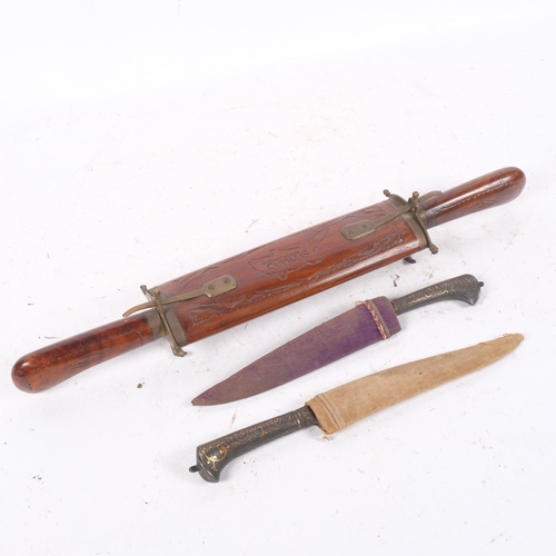 543 - An Indian teak cased carving set (knife and fork), and a pair of Middle Eastern knives, with brass i... 