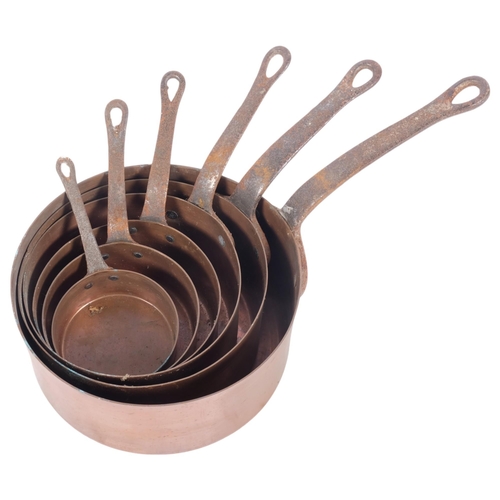 579 - A graduated set of copper saucepans with steel handles, largest 18.5cm