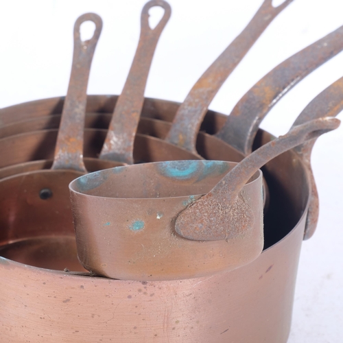 579 - A graduated set of copper saucepans with steel handles, largest 18.5cm