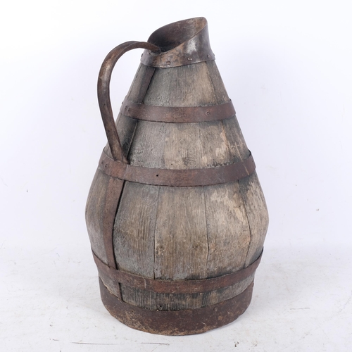 581 - A large Continental coopered oak jug with metal bands, H47cm