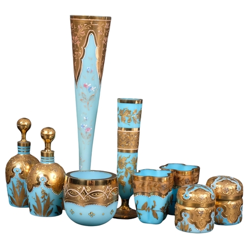 597 - A pair of Vintage blue milk glass bottles and stoppers, with elaborate gilded decoration, matching b... 