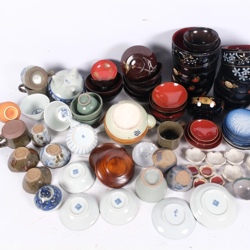 610 - A large quantity of Japanese lacquer and ceramic tea bowls, dishes, teapot, etc