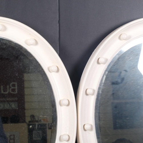 661 - A pair of Vintage oval bevelled-edge mirrors in painted frames, H60cm