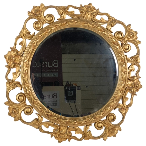 663 - Ornate gilded bevelled-edge wall mirror, in scrolled foliate design frame, 82cm