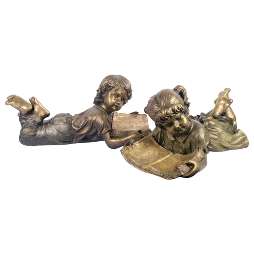 695 - A pair of fibreglass sculptures, boy and girl laying down reading, each measures approx 66cm in leng... 