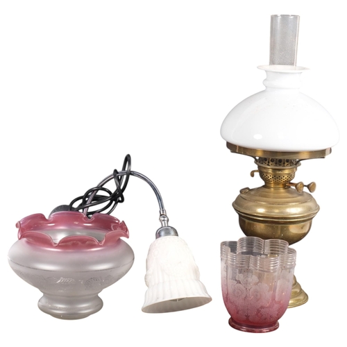 703 - An Antique oil lamp, and a quantity of associated shades, etc