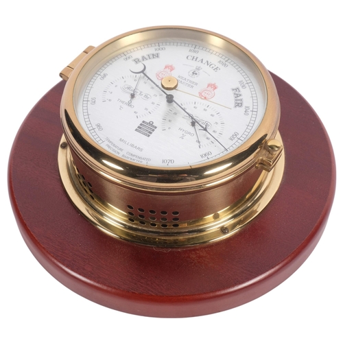 707 - A Sewills Millibars temperature compensated precision barometer, with brass casing and silvered face... 