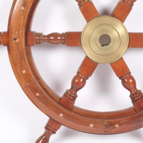 466 - A carved and turned wood ship's wheel, with brass mounts, 63cm across