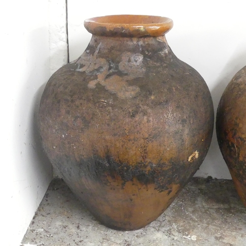 2639 - A glazed terracotta olive oil jar. Diameter 46cm, height 62cm.