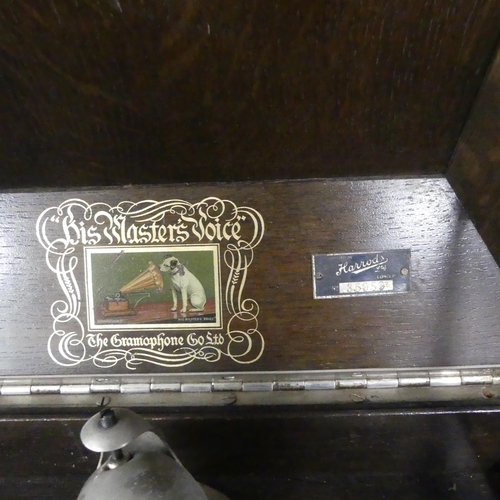 2674 - HMV - An early 20th century oak cased gramophone, with label for Harrods, and a quantitiy of records... 