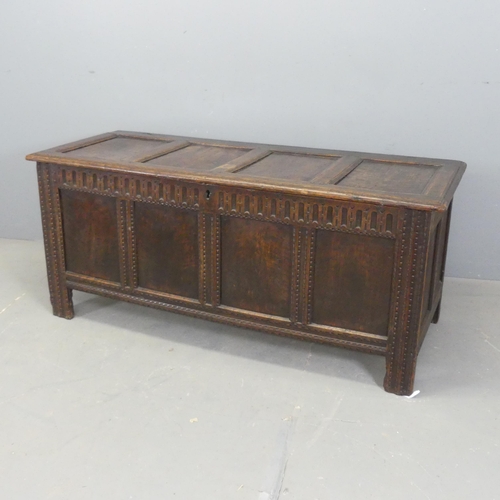 2677 - An 198h century panelled oak coffer, with stile legs and carved decoration. Width 147cm, height 65cm... 