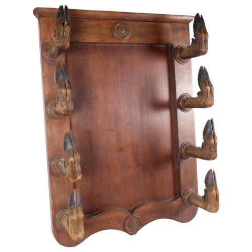 3414 - TAXIDERMY - a Deer Hoof Coat / Gun Rack. 
A large oak panel with eight large red deer hoof slots, or... 