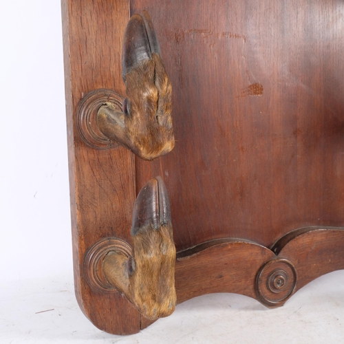 3414 - TAXIDERMY - a Deer Hoof Coat / Gun Rack. 
A large oak panel with eight large red deer hoof slots, or... 