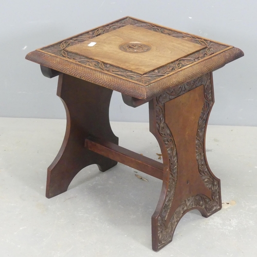 2686 - An early 20th century Arts and Crafts oak foot stool, with carved decoration. Width 35cm, height 42c... 