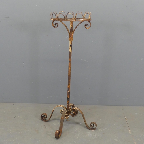 2696 - An antique wrought iron plant stand. Height 93cm.