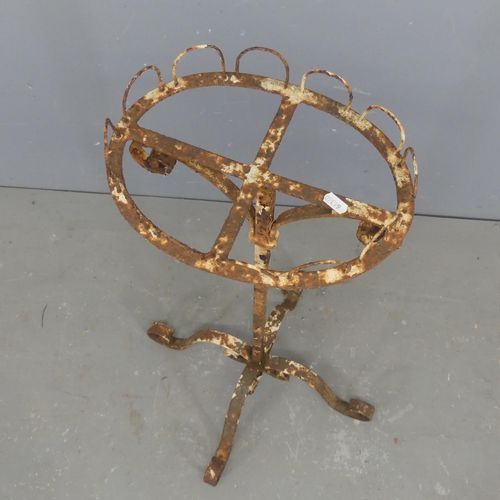 2696 - An antique wrought iron plant stand. Height 93cm.