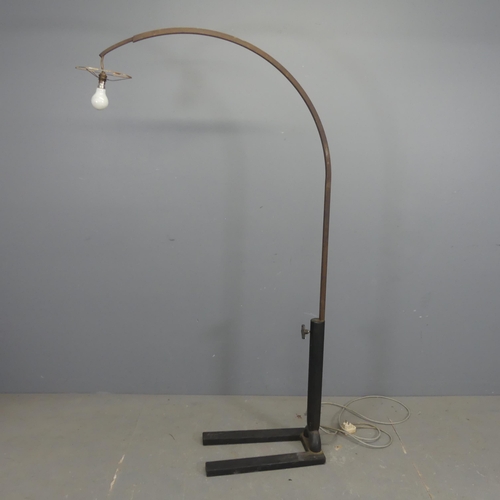 2703 - A contemporary tubular steel arc lamp on industrial cast iron base. Height 172cm.