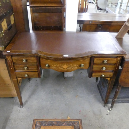 2685 - An Edwardian mahogany and satinwood- strung bow-front writing table, with inlaid decoration, seven d... 