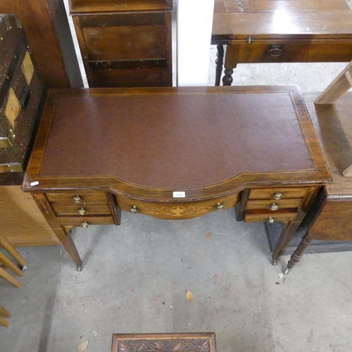 2685 - An Edwardian mahogany and satinwood- strung bow-front writing table, with inlaid decoration, seven d... 