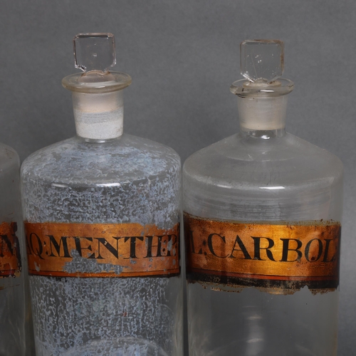 3001 - A group six clear glass apothecary bottles, each with stopper, all have period gold gilt paper label... 