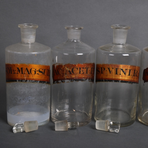 3001 - A group six clear glass apothecary bottles, each with stopper, all have period gold gilt paper label... 