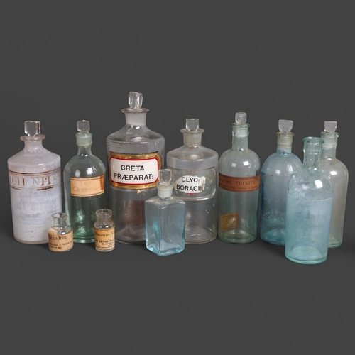 3007 - A collection of clear glass apothecary bottles, including five tinted blue glass bottles, and a sele... 