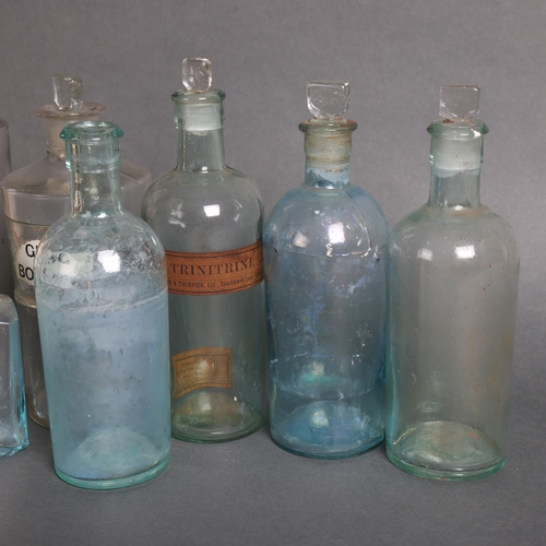 3007 - A collection of clear glass apothecary bottles, including five tinted blue glass bottles, and a sele... 