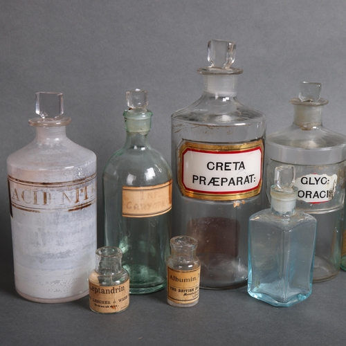 3007 - A collection of clear glass apothecary bottles, including five tinted blue glass bottles, and a sele... 