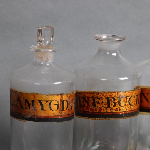 3011 - A group of three apothecary bottles, each with stopper, all with gold gilt period labelling, height ... 