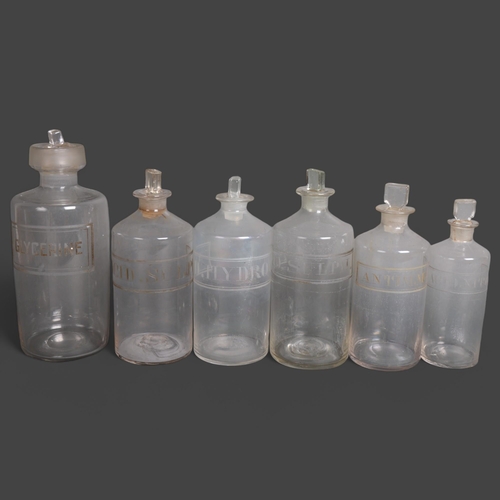 3015 - A group of six clear glass apothecary bottles, each with stopper, all have etched labelling, largest... 